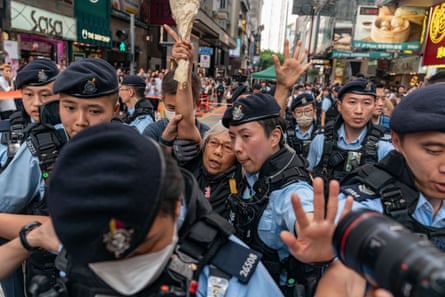 An activist known as Grandma Wong is detained by police in Hong Kong, June 2023, during the annual Tiananmen Square vigil