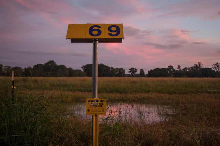 A warning sign marking the location of the Bayou Bridge Pipeline stands across the road from the L’eau Est La Vie Camp. Water often pools and gathers over locations where the pipeline has been buried in the wetlands of southern Louisiana.