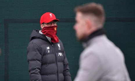 Jürgen Klopp covers his face during a Liverpool training session in March.
