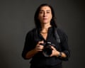 Lynsey Addario poses with her camera.