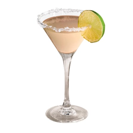 Pink cocktail in martini glass with salt rim and lime slice garnish