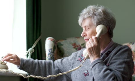 A woman using a traditional telephone at home