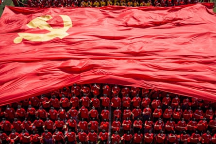 Students displaying the flag of the Chinese Communist party to mark its 100th anniversary during an opening ceremony of the new semester in Wuhan.