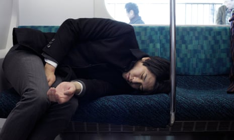 A sleeping businessman during his train commute in Japan