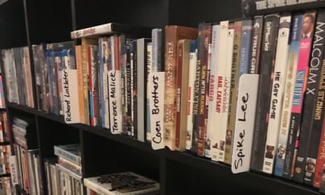 dvds on a shelf divided by labels