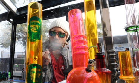A man sells marijuana-related products at his stand during a cannabis convention in Uruguay.
