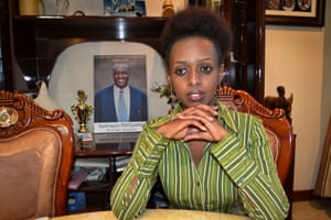 Diane Shima Rwigara sits next to a portrait of her father at her home in Kigali