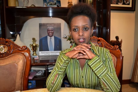 Diane Shima Rwigara sits next to a portrait of her father at her home in Kigali