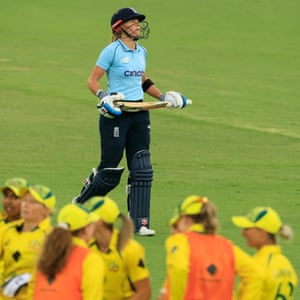 Lauren Winfield-Hill of England walks off after she was caught by Ash Gardner of Australia off the bowling of Megan Schutt.