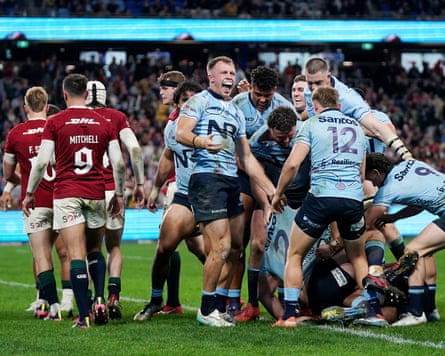 Darby Lancaster celebrates after Ethan Dobbins scores NSW’s second try against the Lions.