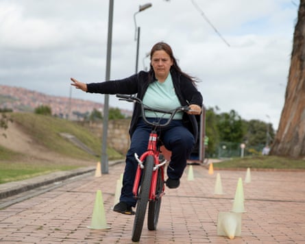 a woman on a bike with her arm out