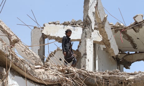 A man stands amongst debris of a destroyed house allegedly hit by a Saudi-led airstrike in Sana’a, Yemen