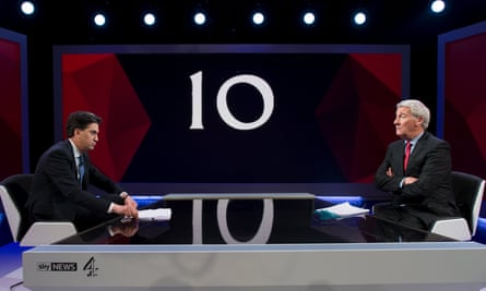 men sit across table from each other