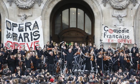 Striking opera musicians wave to the crowd after performing outside the Palais Garnier opera house.