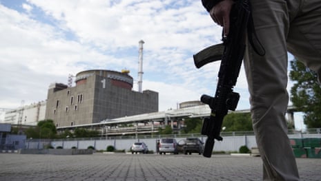 A security person standing in front of the Zaporizhzhia Nuclear Power Plant in Enerhodar earlier this year.