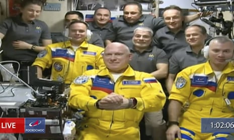 Cosmonauts Sergey Korsakov, Oleg Artemyev and Denis Matveyev on the ISS on 18 March wearing the colours of the Ukrainian flag