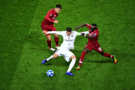 Thiago Silva of PSG is challenged by Sadio Mane of Liverpool.
