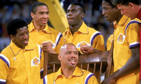 Kareem Abdul-Jabbar is surrounded by his team-mates during his retirement ceremony in 1989, after a 20-year NBA career