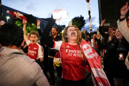Arsenal fans celebrate near the Emirates Stadium.