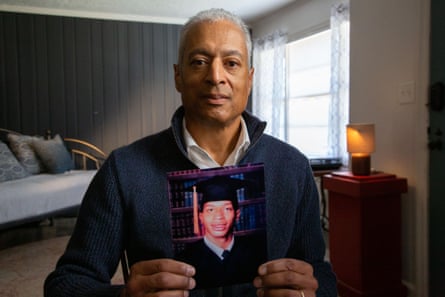 517745Brett Gaines, a DNA relative of Fulton County John Doe David Brown, holding David’s graduation picture. (National Geographic/Tom Beard)