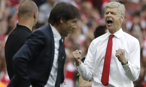 Arsenal team manager Arsene Wenger, right, celebrates his team’s victory next to Chelsea team manager Antonio Conte.