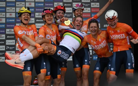 Demi Vollering celebrates with teammates on the podium after her dramatic victory.