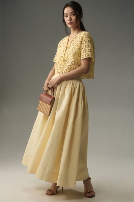Model wearing pale yellow broderie anglaise tie-front top and skirt