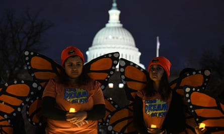 Young immigrants and supporters held a candlelight vigil outside the US Senate on Sunday night amid the shutdown.