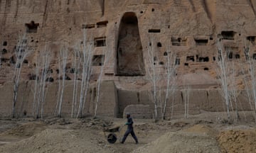 An Afghan man works in front of the ruins of an ancient Buddha statue in Bamiyan, Afghanistan