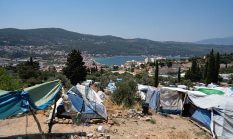 Refugee tents on the hillside on the island of Samos with sea in background