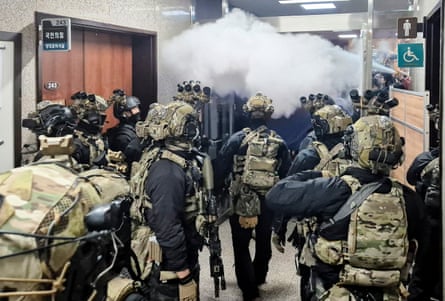 Soldiers storm a building in the corridor