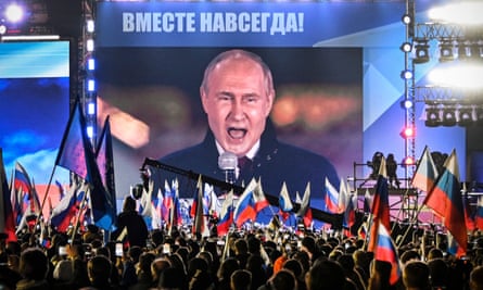 An image of Russian President Vladimir Putin appears on a screen in Moscow's Red Square