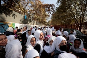 Female primary school students leave school after a class in Kabul