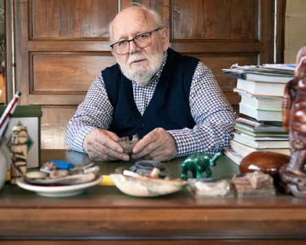 A man with white hair, checked shirt and tanktop