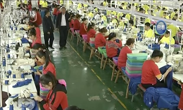 Screengrab of file video footage from China’s CCTV of Muslim trainees in a garment factory in Xinjiang