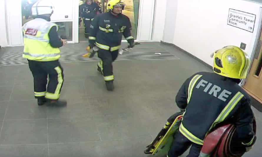A CCTV still shows the first firefighters entering Grenfell Tower