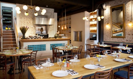 Aegean turquoise tiling, hanging globe lamps and distressed white brick walls in Yeni's dining room