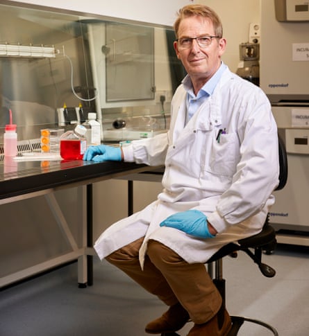 Brendon Noble in a white lab coat in a lab