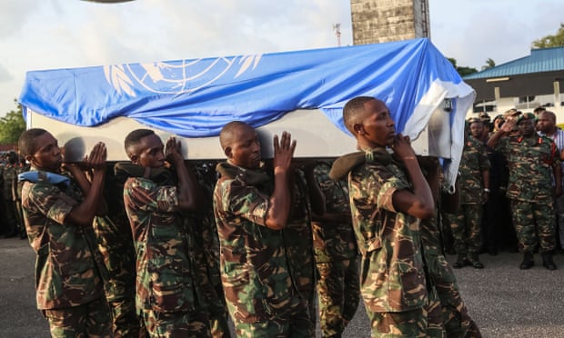 Soldiers carry coffin of Tanzanian peacekeeper killed in DRC.