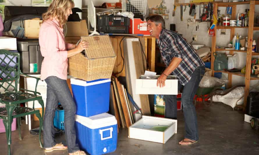 Couple stacking boxes in garage
