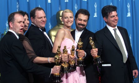 ‘Shakespeare in Love’ Best Actress winner Gwyneth Paltrow (center) is joined by Harvey Weinstein (center left) backstage as they celebrated their win of Best Picture at the 1999 Academy Awards.