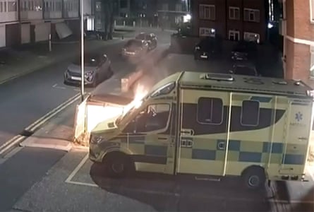 A CCTV screengrab of one of the Hatzola ambulances set on fire by masked suspects, Golders Green, London.