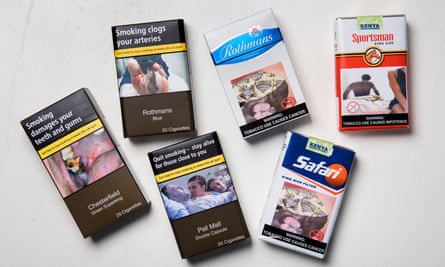 British packets of cigarettes, with stark warnings, beside packs from Africa.