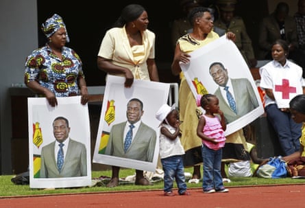 Women hold portraits of Mnangagwa at his inauguration ceremony