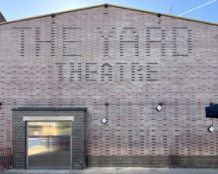 The Yard Theatre's brick facade with faded lettering above a glass entrance door