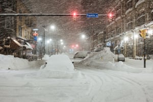 Vehicles are abandoned in heavy snowfall in downtown Buffalo