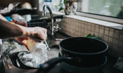 Man washing dishes at a sink