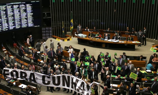 Pro-Rousseff lawmakers hold up a banner against Eduardo Cunha that reads ‘Get out Cunha’.