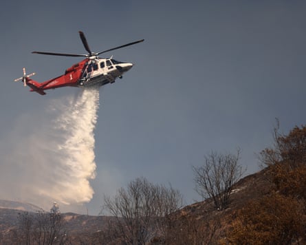 A Los Angeles Fire Department helicopter drops water to contain the Walnut Fire in the Wildwood Canyon, California.