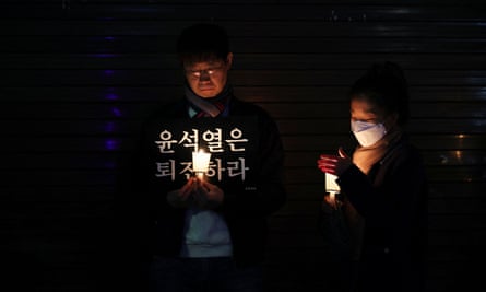 A man holds a placard during a candlelight vigil in Seoul.